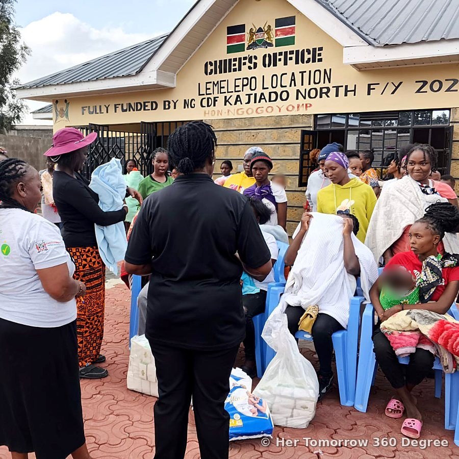 Mothers gather with bags of unga and diapers outside the Chief's Office